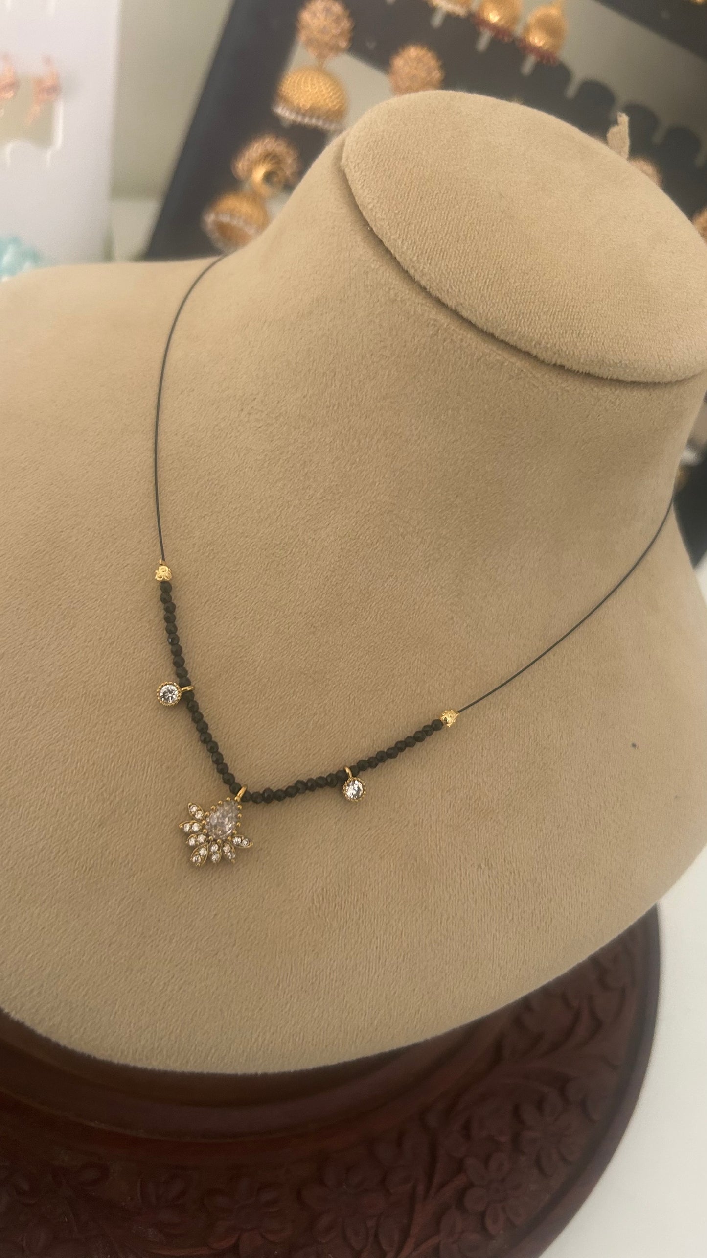 Invisible black beads with white pendent