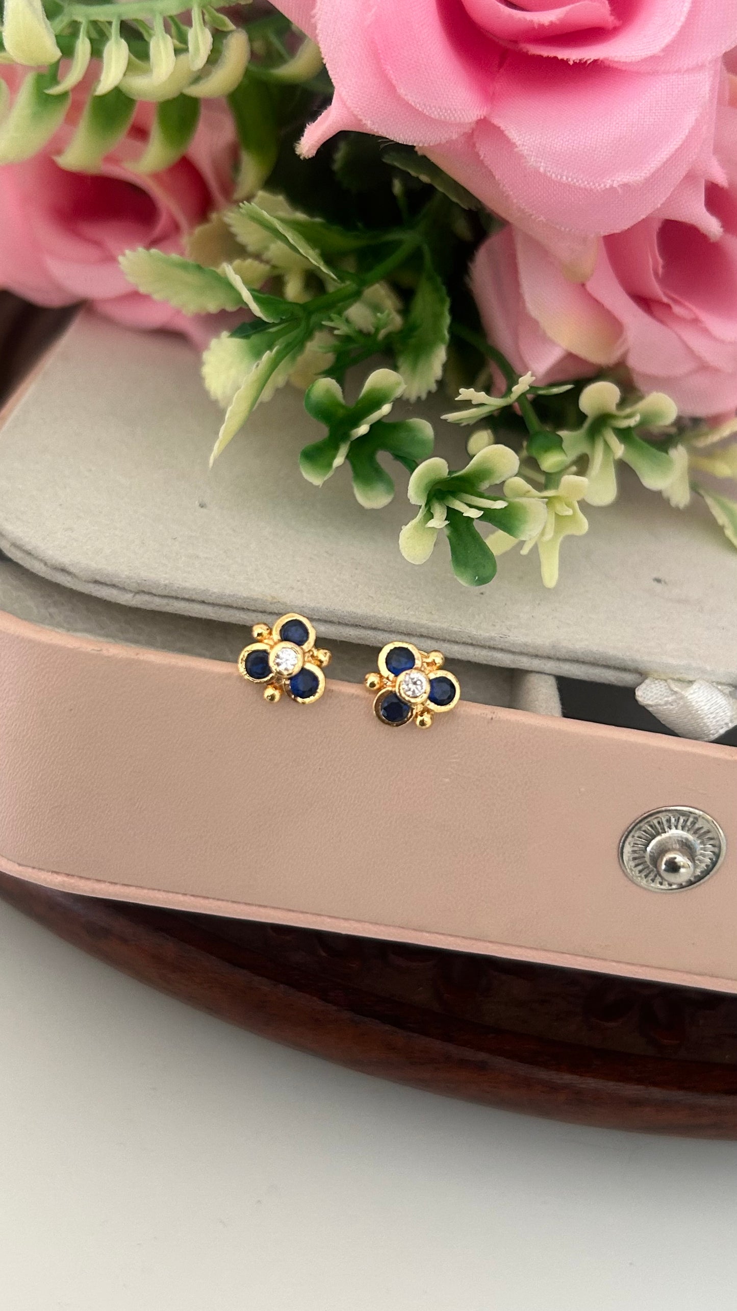 "Polished Panchaloham Stud Earrings – Blue & White Stone Floral Design"