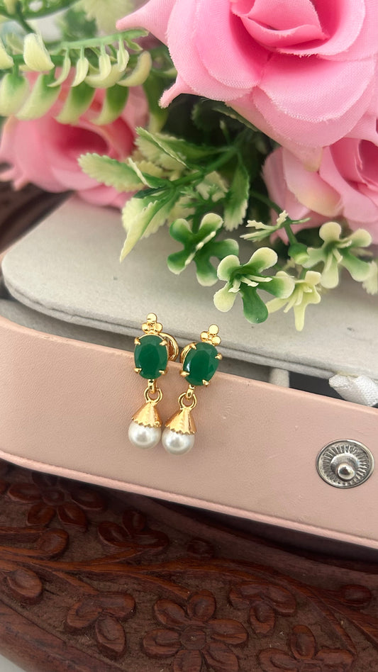 "Elegant Panchaloham stud earrings with polished finish, featuring green stone accents and pearl drop design – perfect for traditional & festive wear."