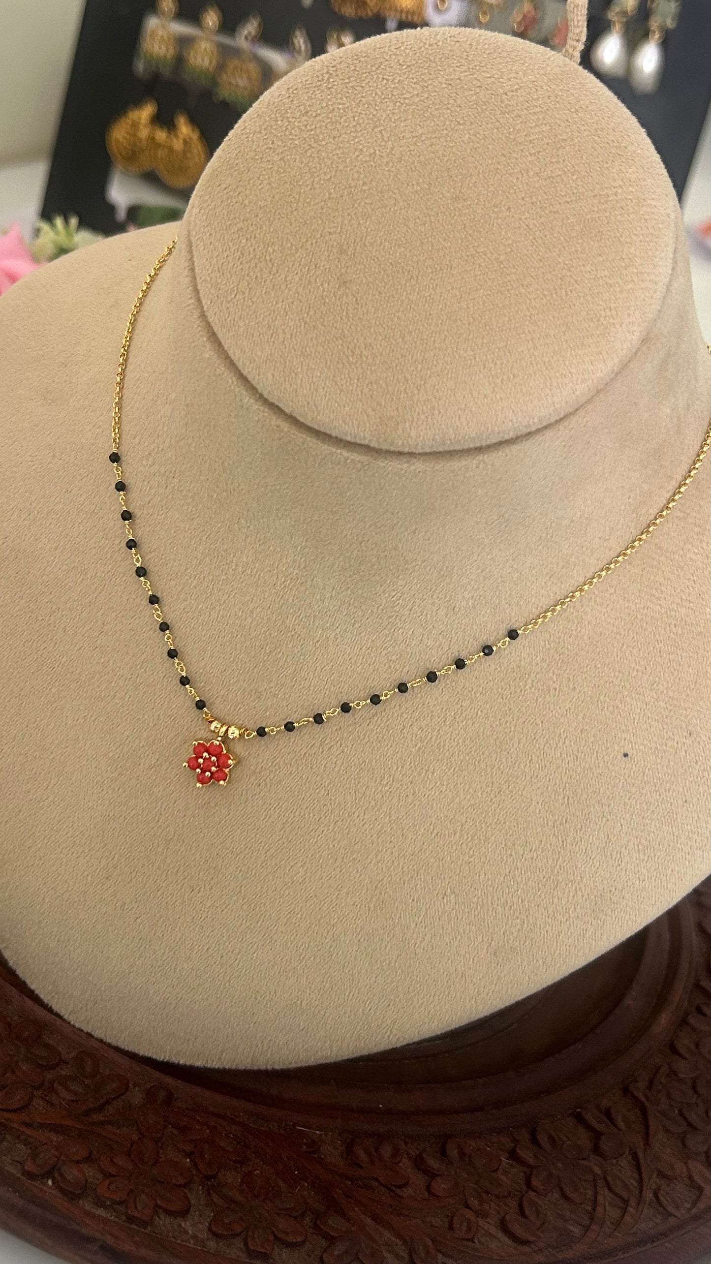 Black bead with coral pendent in 15 inches