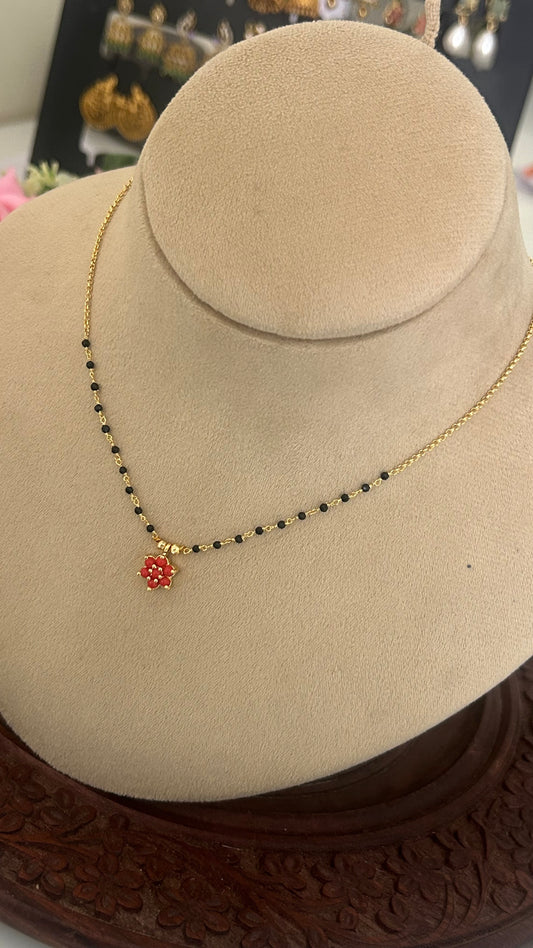 Black bead with coral pendent in 15 inches