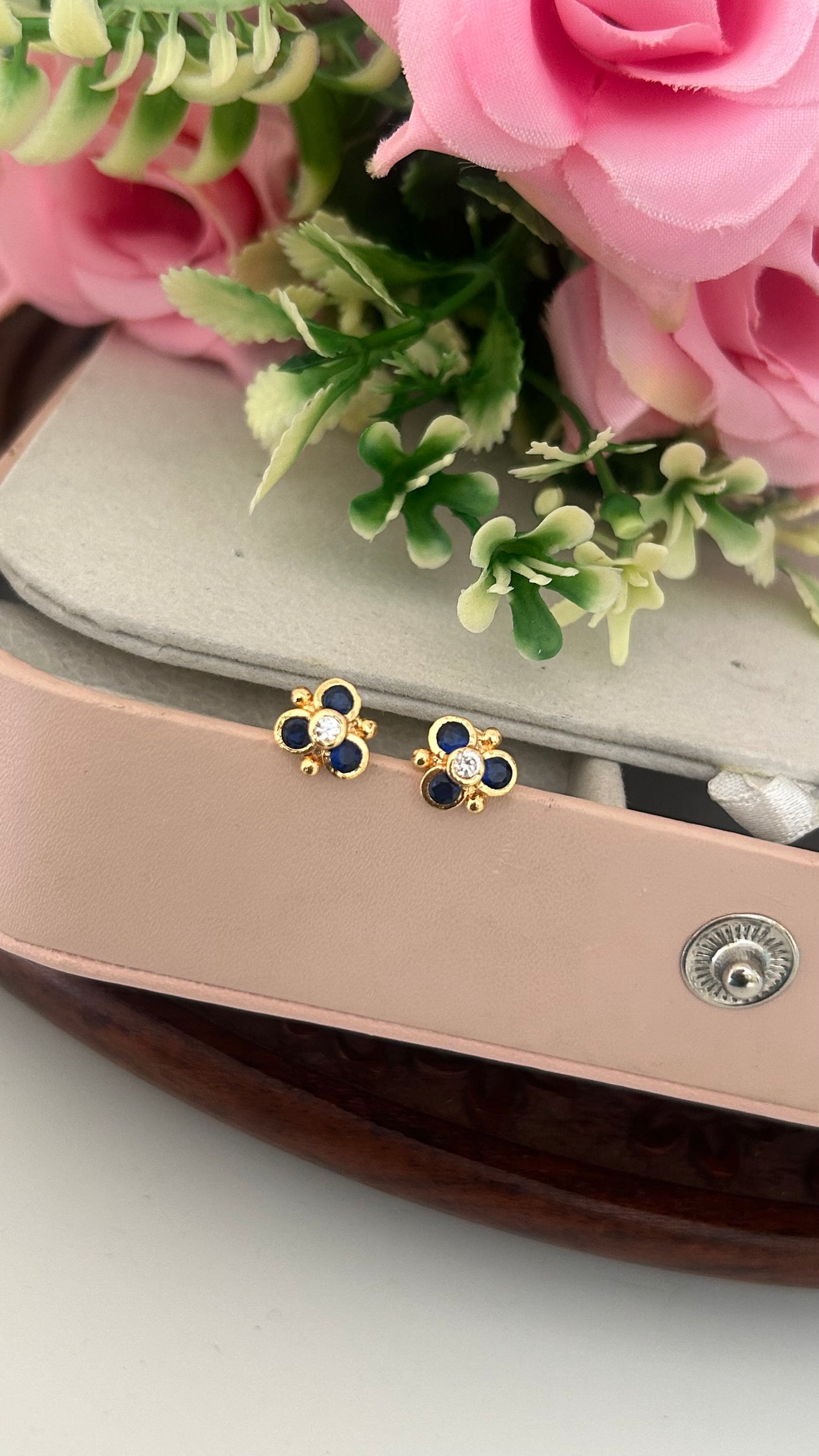 "Polished Panchaloham Stud Earrings – Blue & White Stone Floral Design"