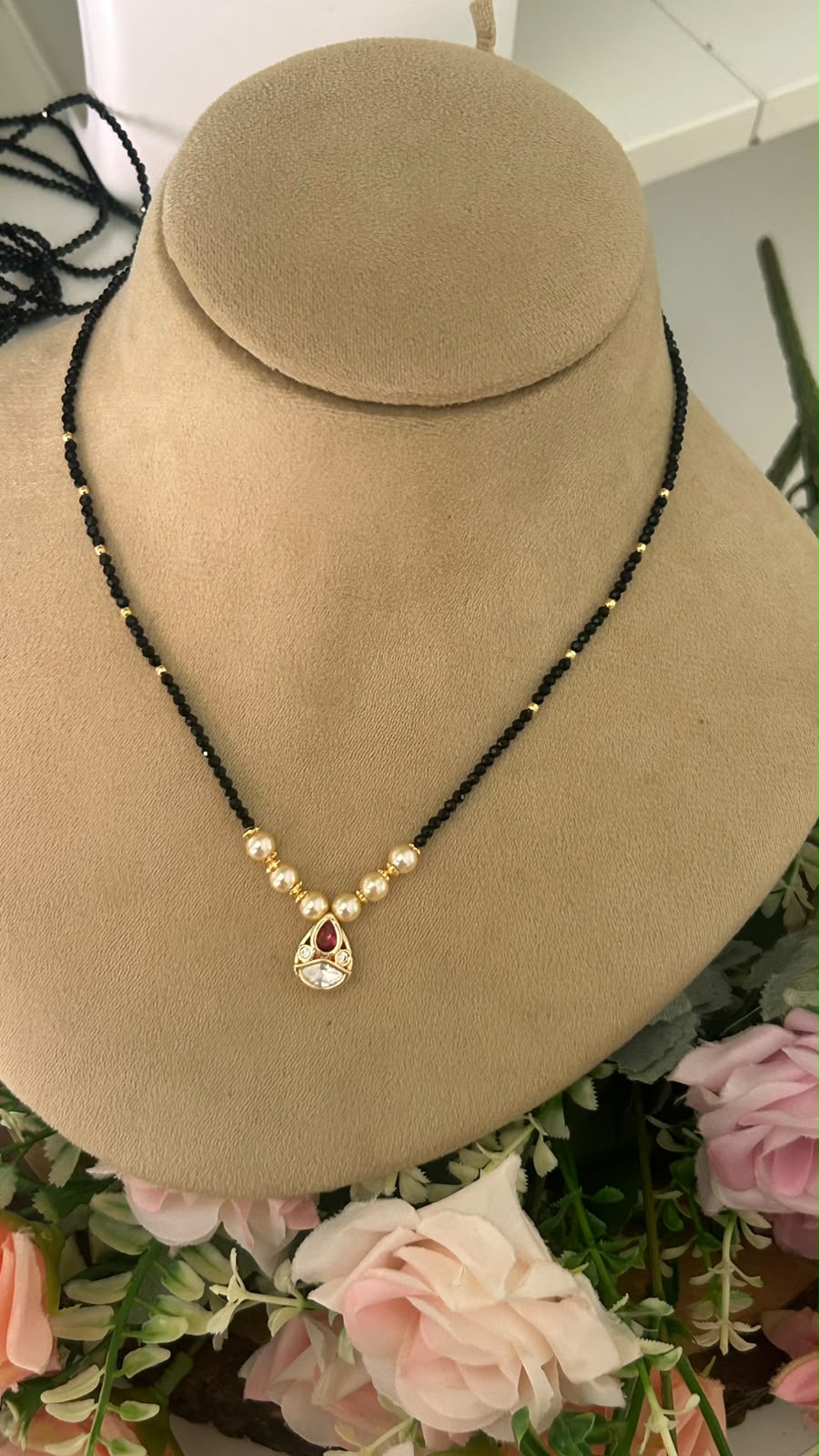 Elegant Single Line Black Beads Mangalsutra with Ruby Red Stone Teardrop Pendant & Gold-Tone Pearl Accents for Women