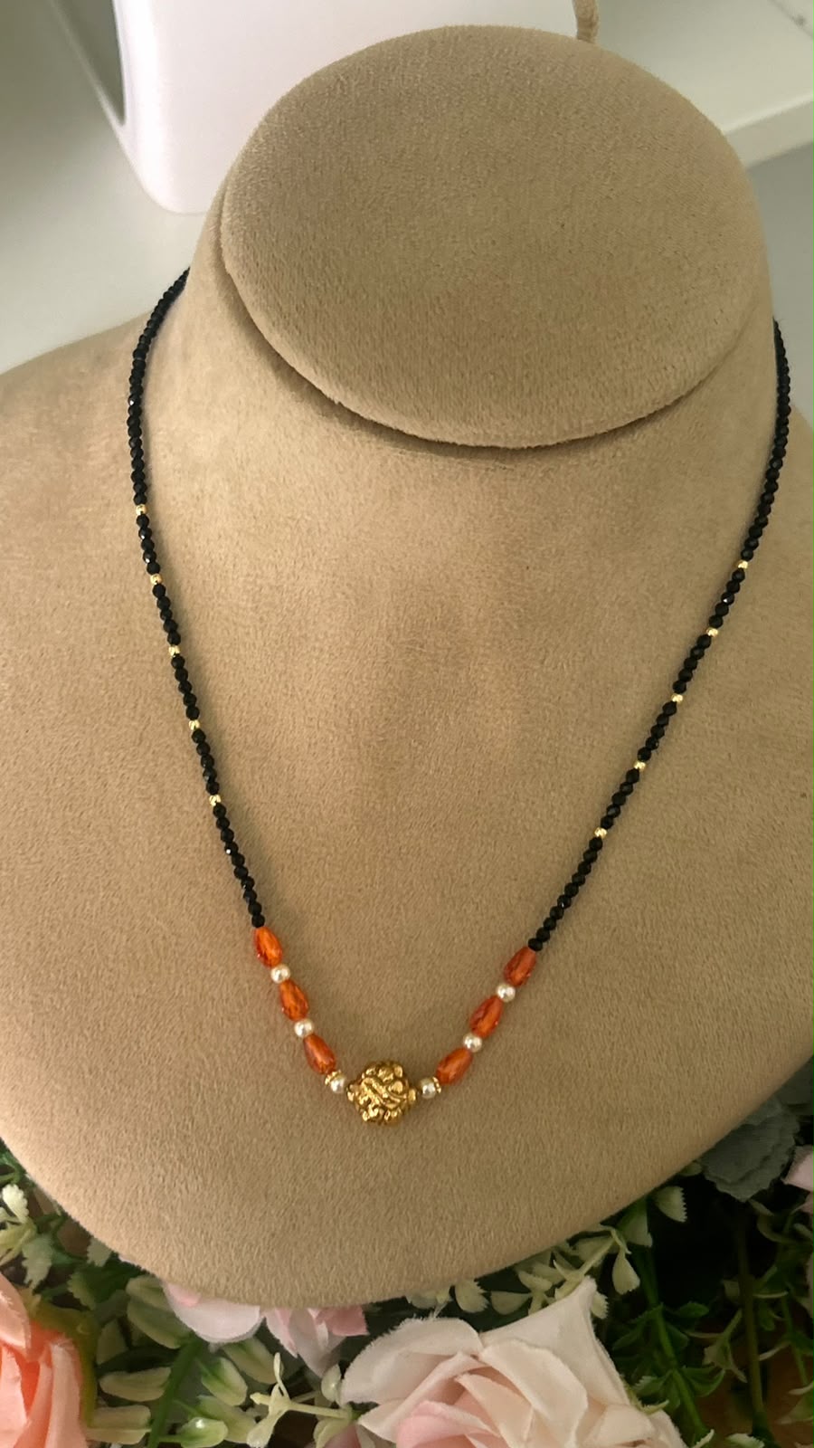 Elegant Single Line Black Beads Mangalsutra with Orange Crystal Beads, Pearl Accents & Gold-Tone Floral Centre Bead for Women