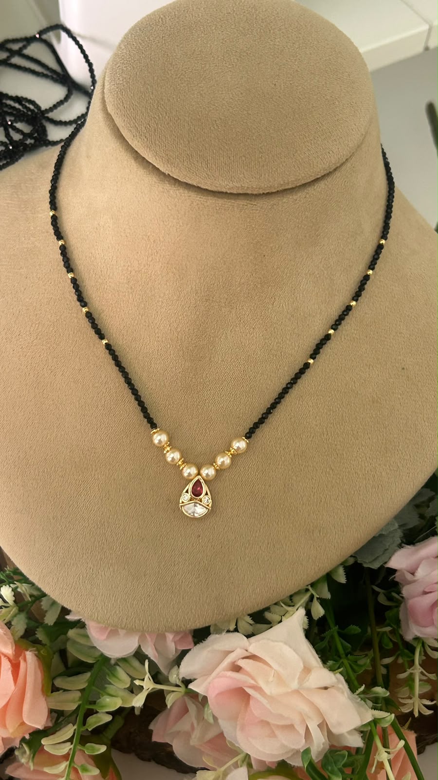 Elegant Single Line Black Beads Mangalsutra with Ruby Red Stone Teardrop Pendant & Gold-Tone Pearl Accents for Women