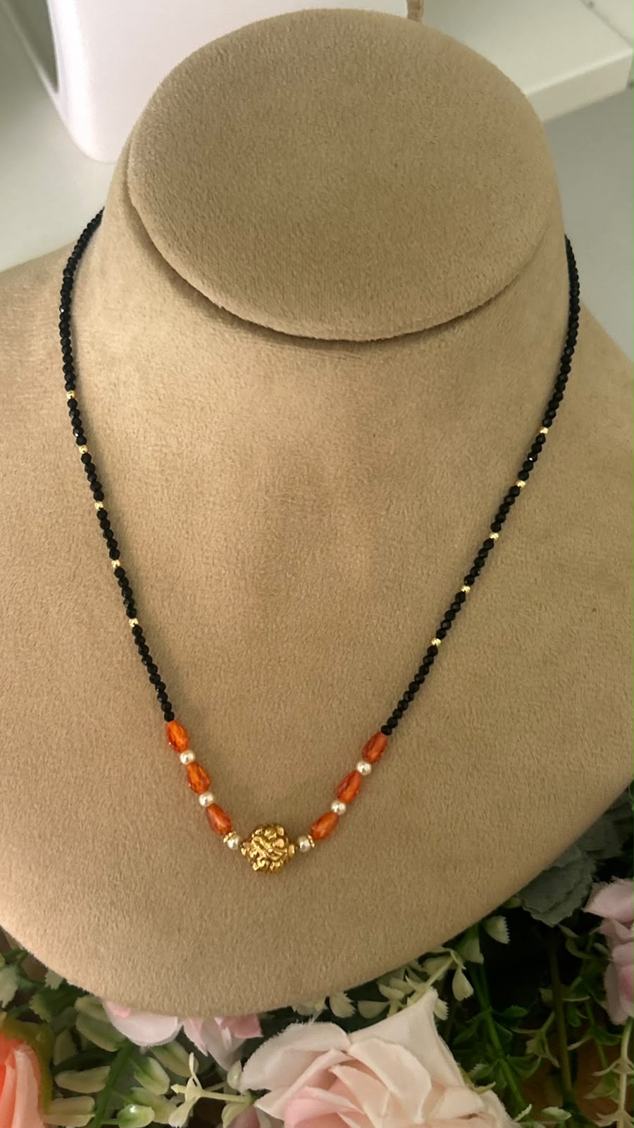 Elegant Single Line Black Beads Mangalsutra with Orange Crystal Beads, Pearl Accents & Gold-Tone Floral Centre Bead for Women