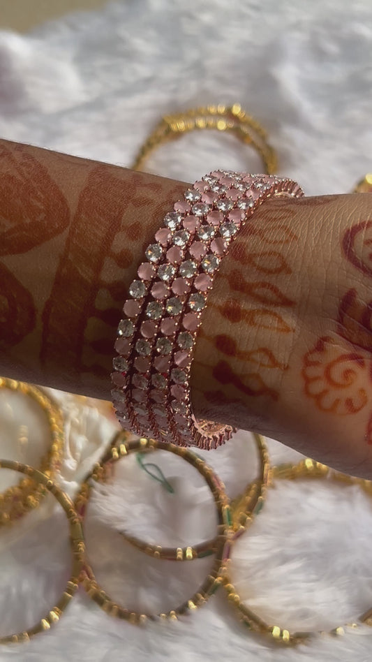 Stone bangles in peach colour